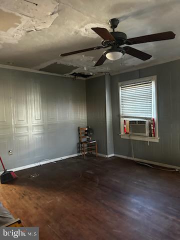 spare room featuring hardwood / wood-style flooring, ceiling fan, and cooling unit