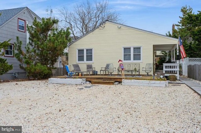 rear view of property with a wooden deck