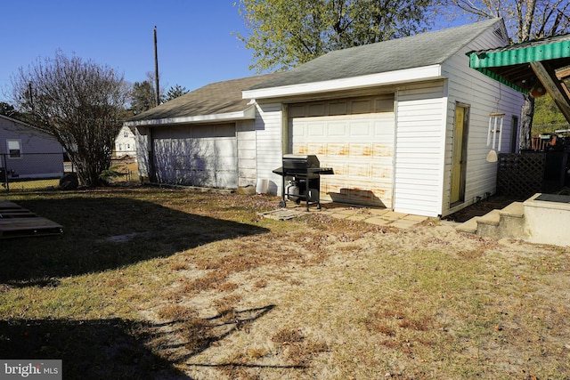 garage featuring a lawn