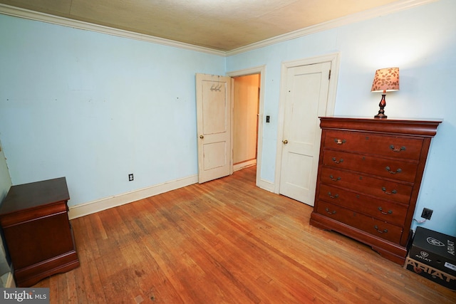 unfurnished bedroom featuring light hardwood / wood-style flooring and ornamental molding