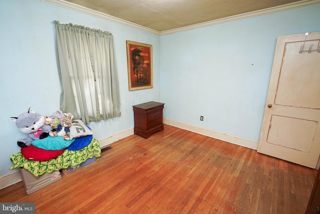 interior space featuring crown molding and hardwood / wood-style floors