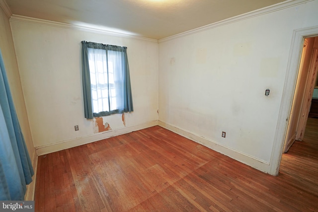 unfurnished room featuring wood-type flooring and ornamental molding