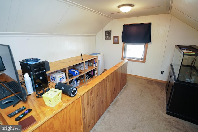 carpeted office featuring vaulted ceiling