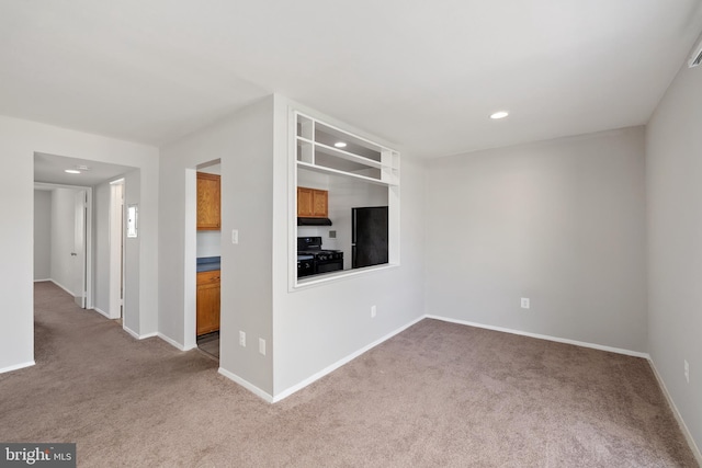 unfurnished living room featuring light carpet