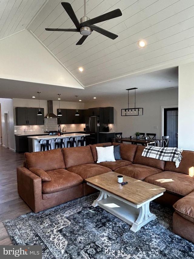 living room featuring dark hardwood / wood-style floors, ceiling fan, wood ceiling, and high vaulted ceiling