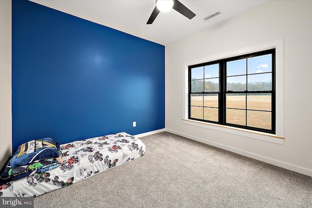 unfurnished bedroom with ceiling fan and carpet