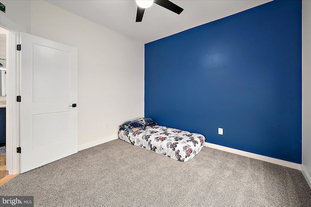 unfurnished bedroom featuring carpet and ceiling fan