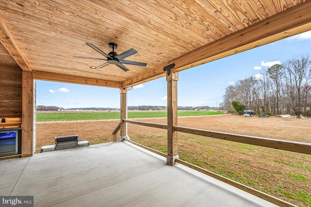 view of patio featuring ceiling fan and a rural view