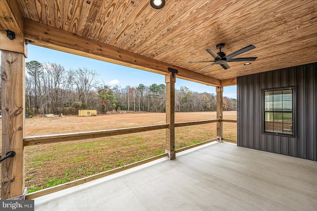 unfurnished sunroom with ceiling fan and wood ceiling