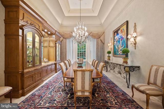 dining area featuring a notable chandelier, a raised ceiling, and crown molding