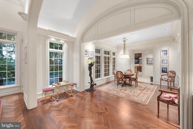 dining room featuring parquet flooring and ornamental molding