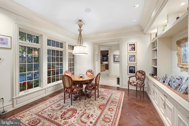 dining area featuring dark parquet flooring and crown molding