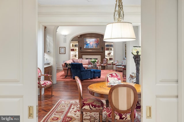 dining area featuring dark parquet flooring and ornamental molding