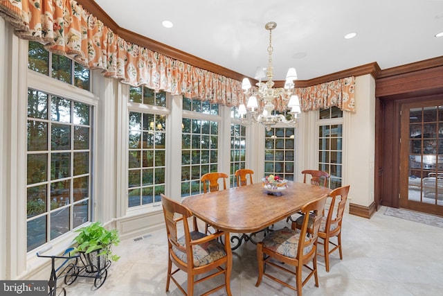 dining space with a chandelier, ornamental molding, and a healthy amount of sunlight