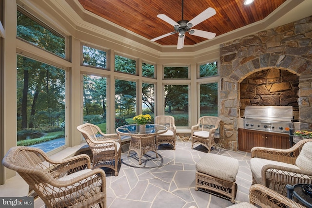 sunroom / solarium with a wealth of natural light, wooden ceiling, and ceiling fan