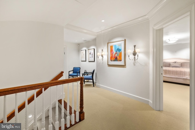 hallway with light colored carpet and crown molding