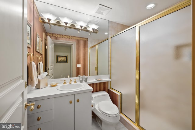 bathroom featuring tile patterned flooring, vanity, toilet, and an enclosed shower