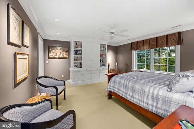 carpeted bedroom with ceiling fan and crown molding