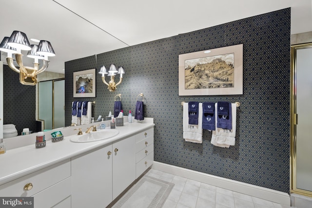 bathroom with tile patterned floors, vanity, toilet, and a shower with door