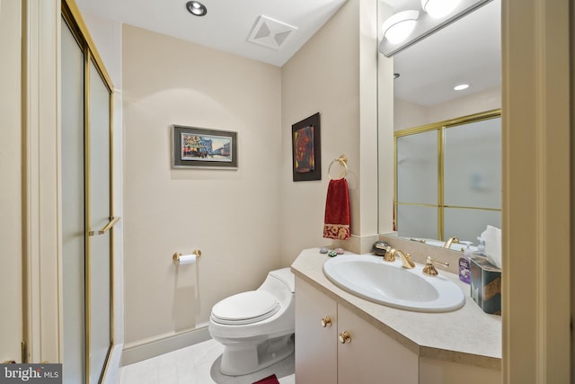 bathroom featuring tile patterned flooring, vanity, toilet, and an enclosed shower