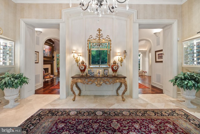 foyer with crown molding, a healthy amount of sunlight, and hardwood / wood-style flooring