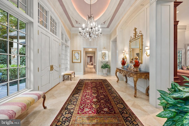 interior space with crown molding, a healthy amount of sunlight, and a high ceiling