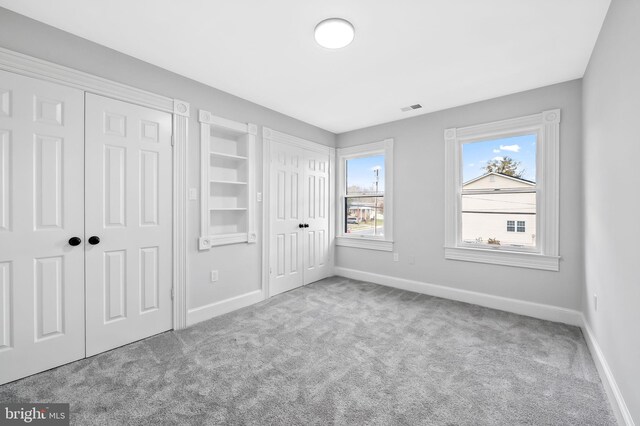 unfurnished bedroom with light colored carpet