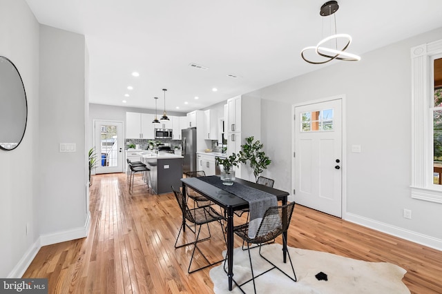 dining space with light hardwood / wood-style floors