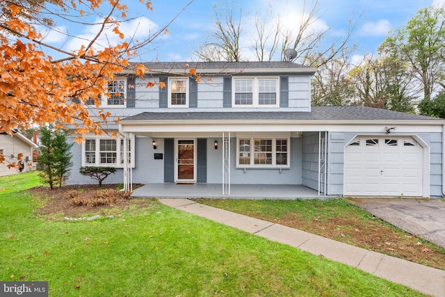 view of property featuring a front yard, a porch, and a garage