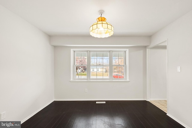 spare room with hardwood / wood-style flooring