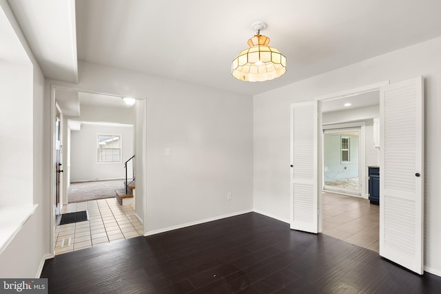 unfurnished room with dark hardwood / wood-style flooring