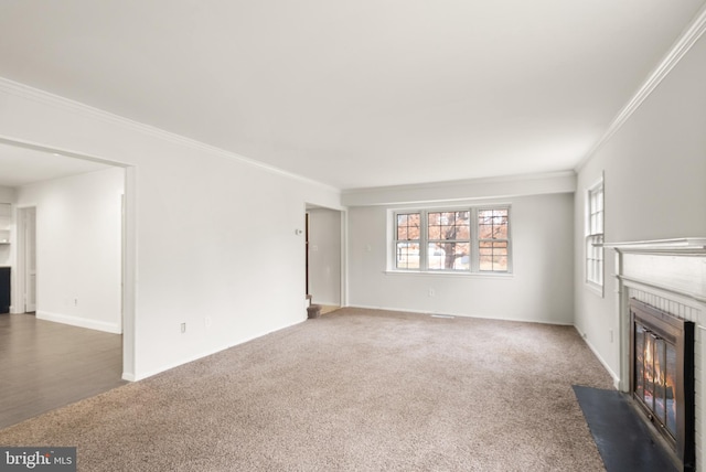 unfurnished living room featuring a fireplace, dark carpet, and ornamental molding