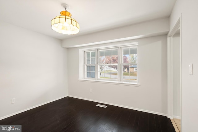 unfurnished room featuring hardwood / wood-style flooring