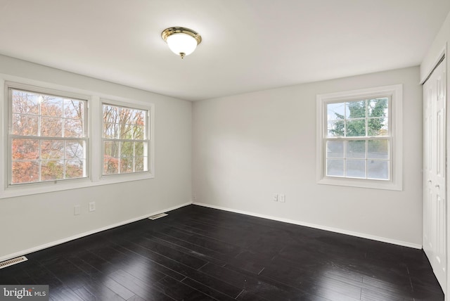 unfurnished room featuring dark hardwood / wood-style floors