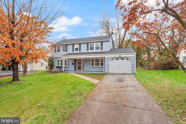 view of front property with a front lawn, covered porch, and a garage