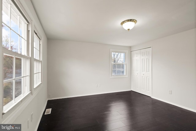 spare room featuring dark hardwood / wood-style floors