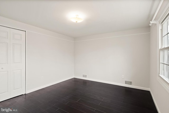 interior space featuring a closet and dark hardwood / wood-style floors