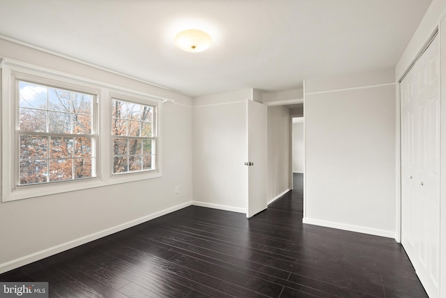 unfurnished room featuring dark hardwood / wood-style flooring