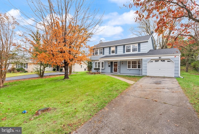 view of front of home with a porch, a garage, and a front lawn