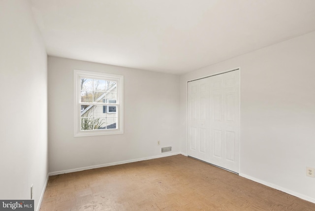 unfurnished bedroom with a closet and light hardwood / wood-style flooring