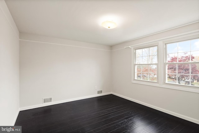 unfurnished room featuring dark wood-type flooring