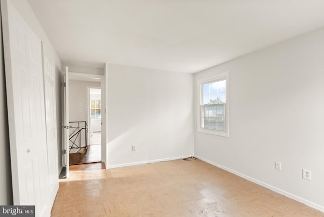 empty room featuring plenty of natural light and light hardwood / wood-style flooring