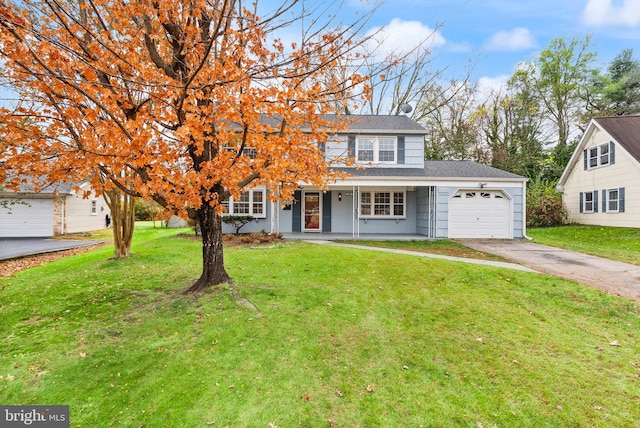 view of front of home with a front lawn, a porch, and a garage