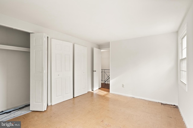 unfurnished bedroom with light wood-type flooring