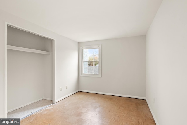 unfurnished bedroom with a closet and light wood-type flooring