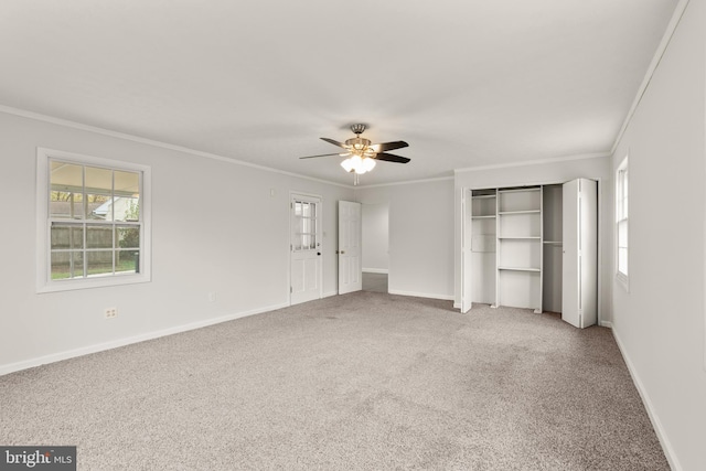 unfurnished bedroom with carpet, ceiling fan, and crown molding