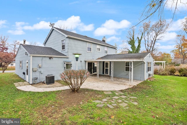 rear view of house with a lawn, a patio, and central AC unit