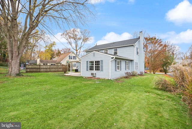 back of property featuring a patio area and a lawn