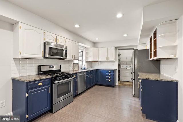 kitchen featuring sink, light hardwood / wood-style flooring, blue cabinetry, appliances with stainless steel finishes, and white cabinetry