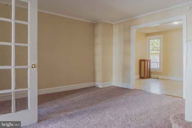 spare room featuring light colored carpet and crown molding